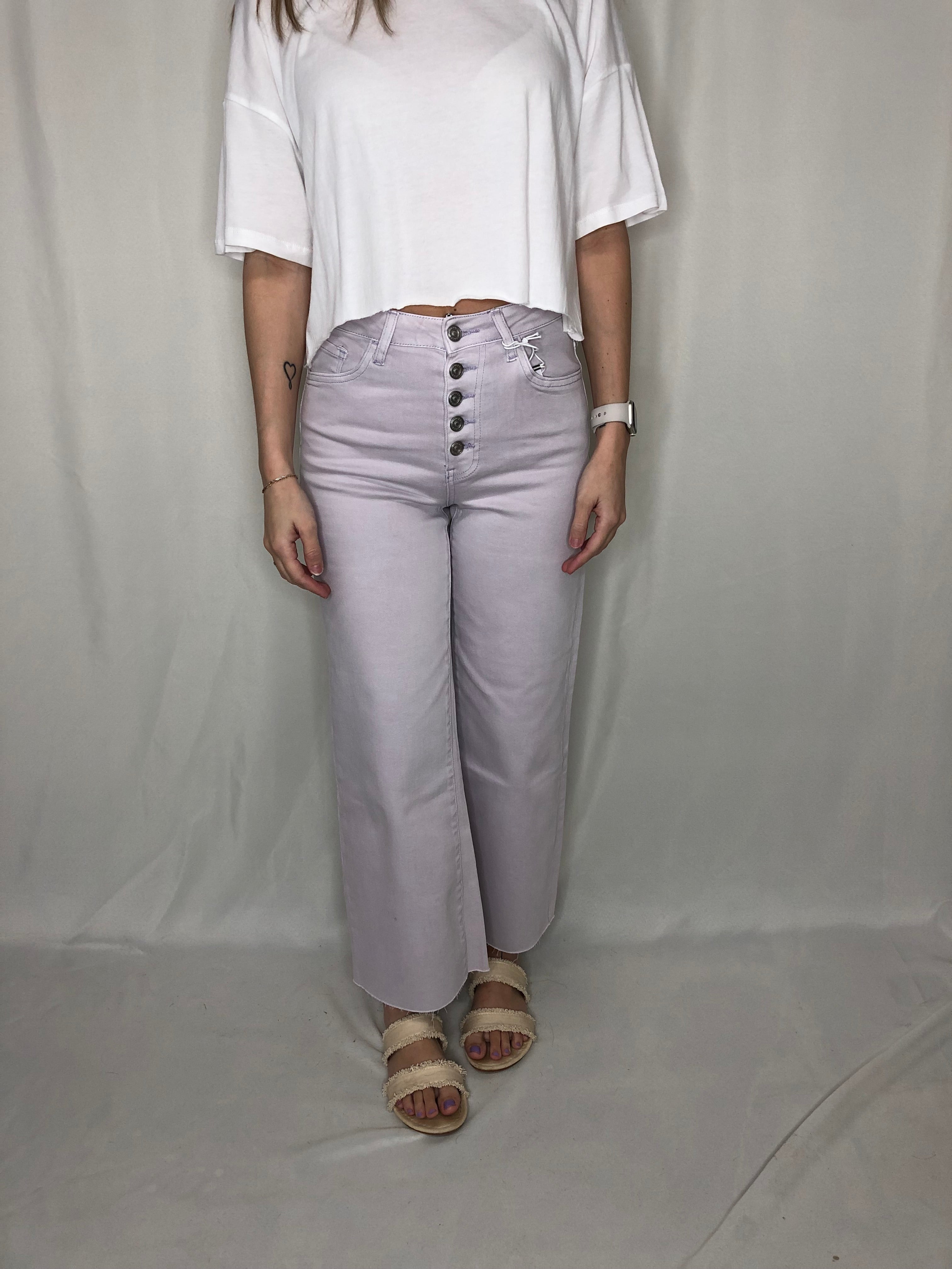High-Waisted Stretch Wide Leg Jeans – Light Wash Person wearing a white outfit with light purple pants and sandals on a plain background