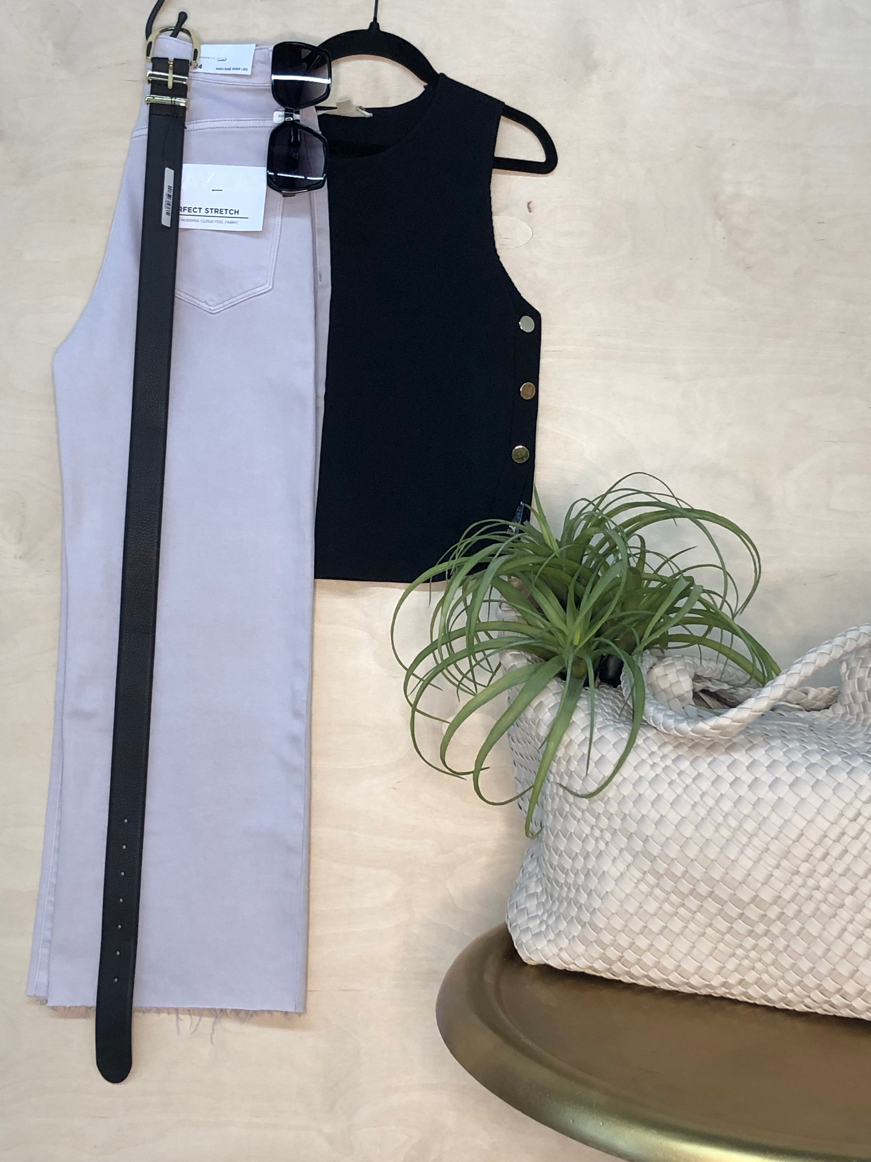 High-Waisted Stretch Wide Leg Jeans – Light Wash  Black tank top and gray pants with a plant and woven bag on a light surface