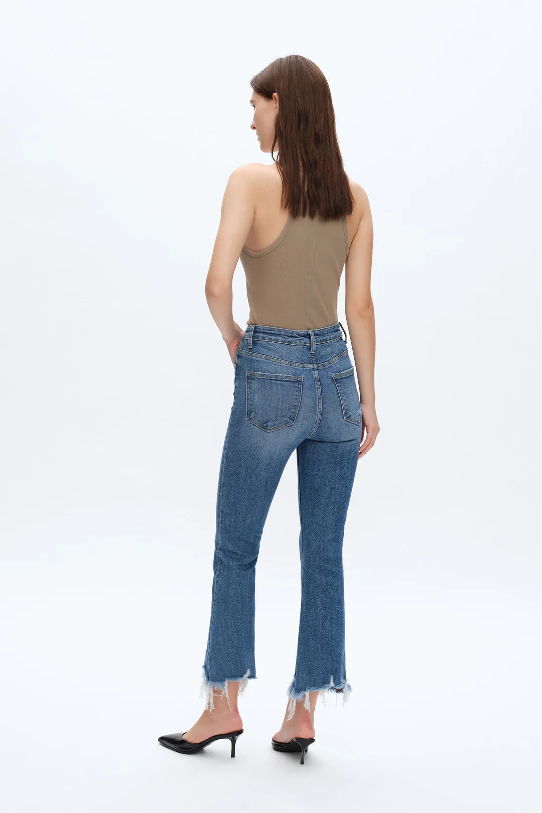 Rita High Rise Frayed Hem Ankle Flare Jeans Woman wearing blue jeans and a beige top on a white background